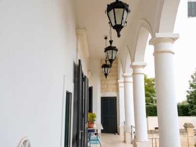 ...ci conduce alla loggia sul cui soffitto pendono delle lanterne scure